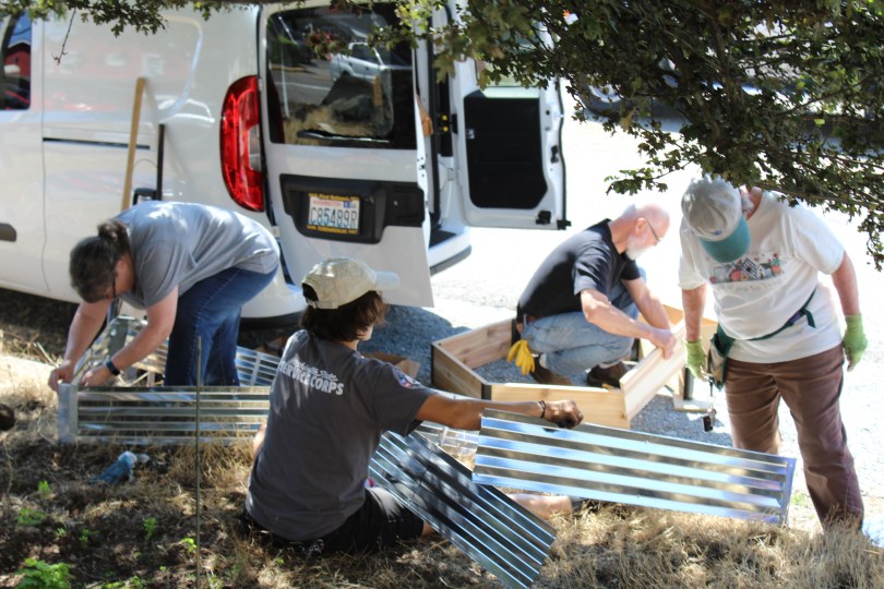 Volunteers building the St. E. food and flower garden beds, 2019.